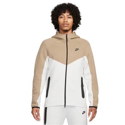 beige nike tech hoodie.